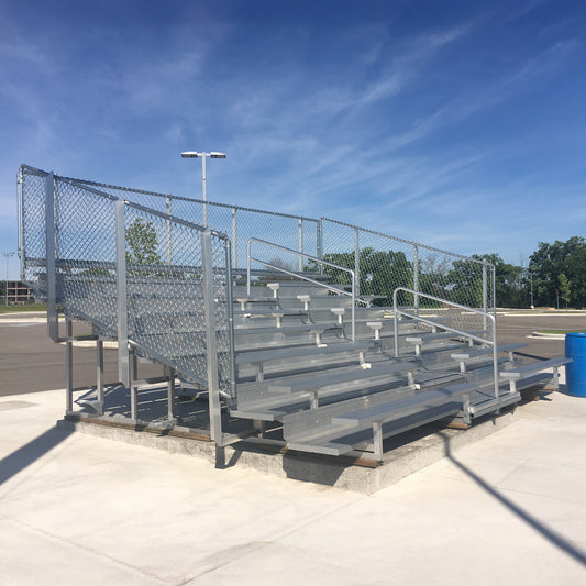Model #B8R-25-1-GR8. 8 row bleachers with 4' aisle and black vinyl fenceguard instead of chain link.