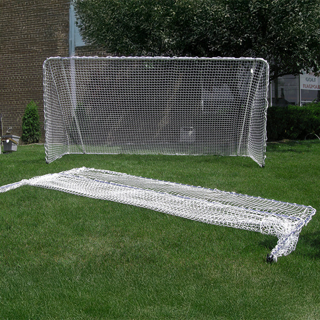 A Folding Aluminum Soccer Goal is set up on grass with another folded net in front, ideal for portable play. A brick building and shrubs are in the background.