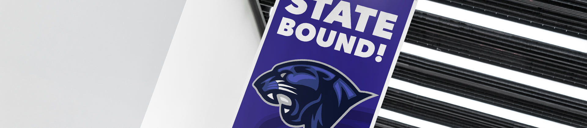 A vertical purple banner with the words “STATE BOUND!” in white, above an illustrated panther head, hanging indoors near a modern ceiling with black beams.