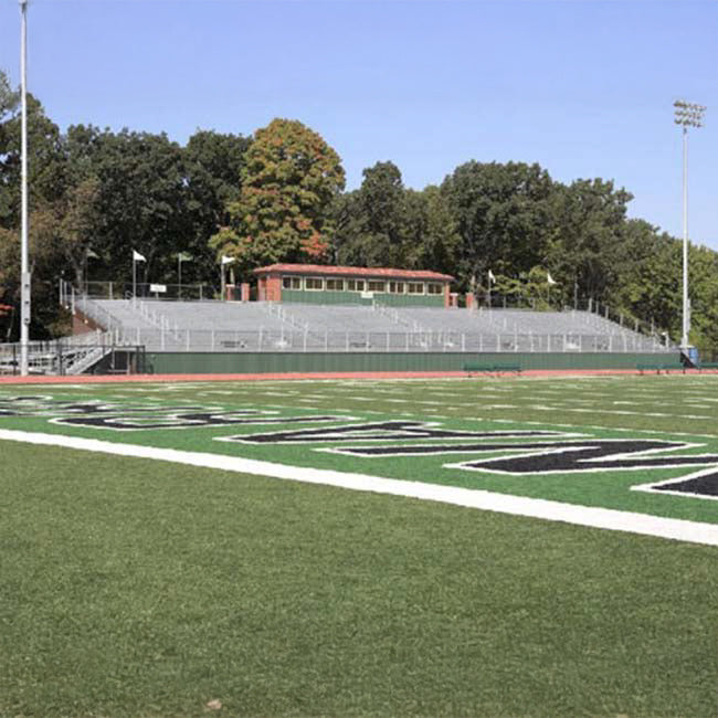 Stadium seating with press box for football field.