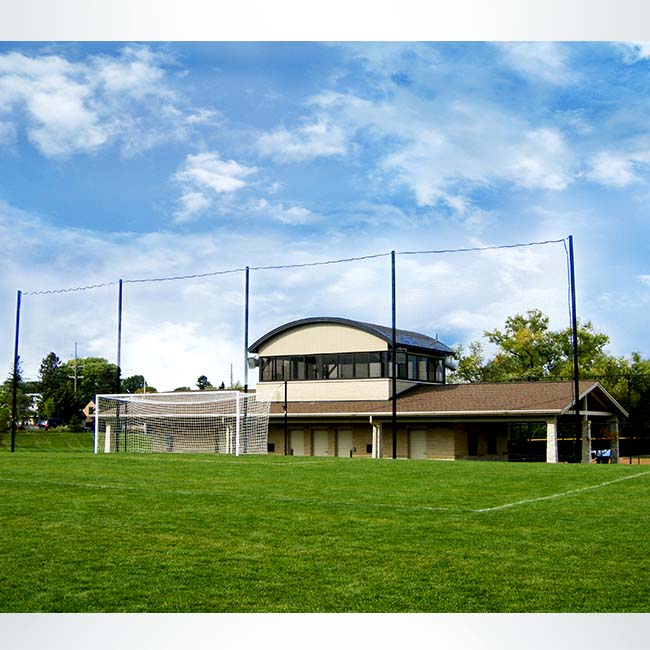 Custom backstop netting system behind soccer goal on soccer field.