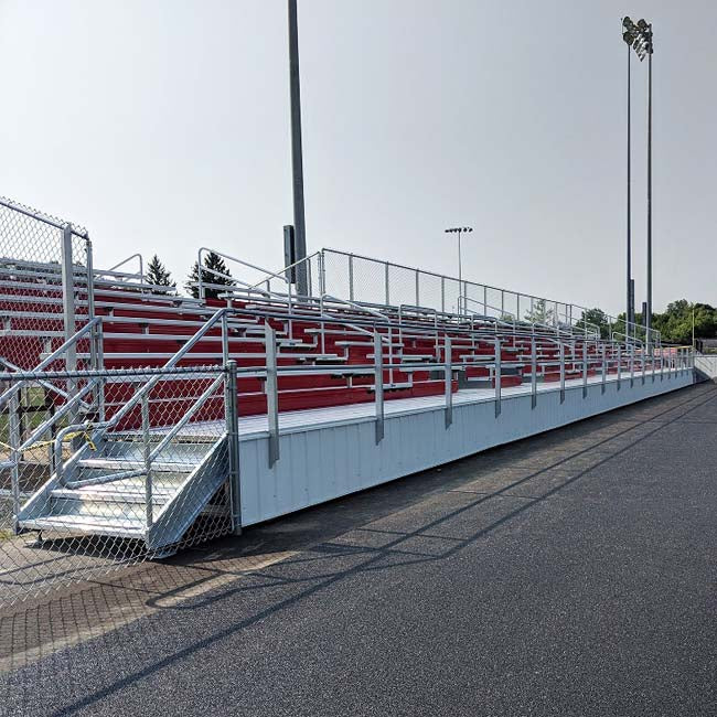 Custom elevated bleachers with red risers.