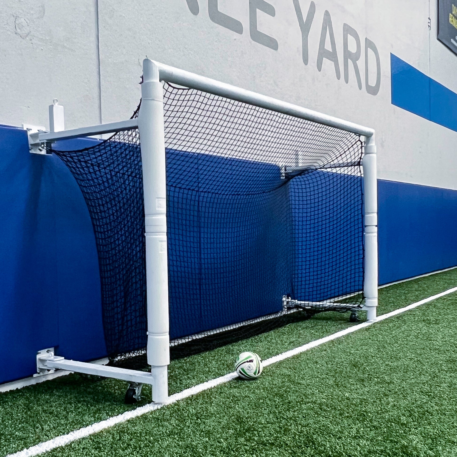 Custom back depth soccer goal with hinged sides.