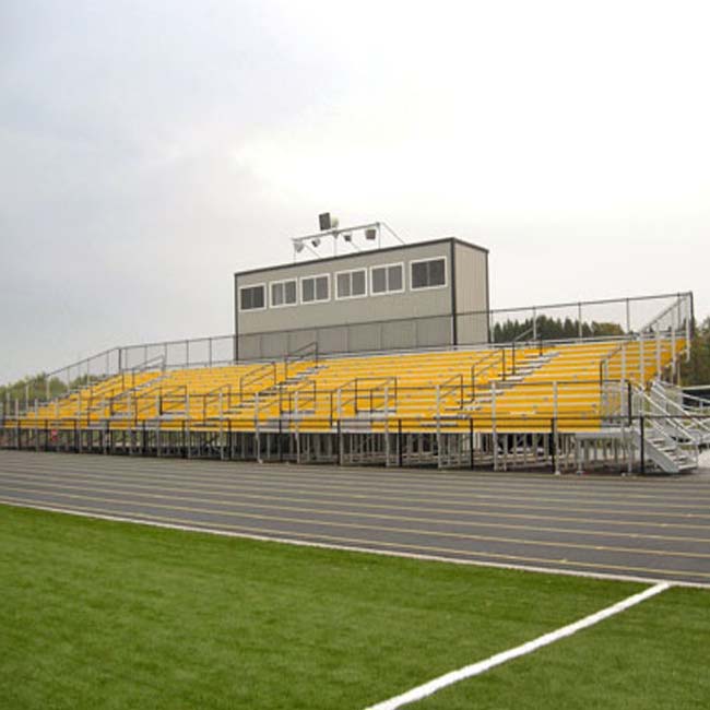 Elevated bleachers with yellow risers and press box.