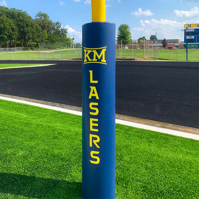 Blue football goal post pad with yellow lettering and school logo.