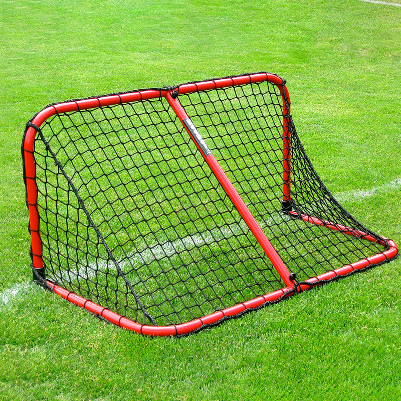 Folding Aluminum Soccer Goals are set up on a green field with a red metal rebound net featuring black mesh. White painted lines mark the grass, creating an ideal setup for soccer or lacrosse practice.