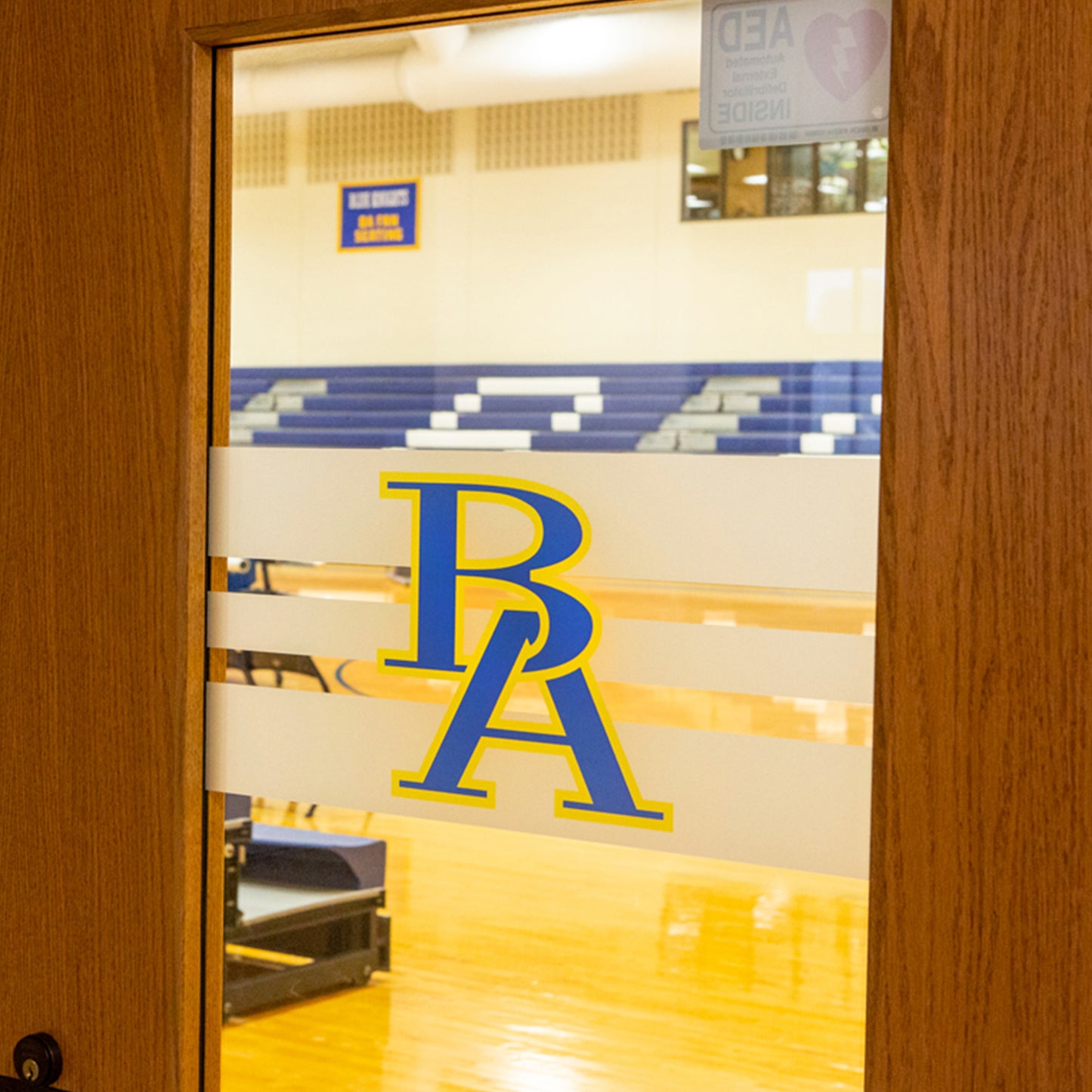 Frosted etched vinyl graphic on gym doors.