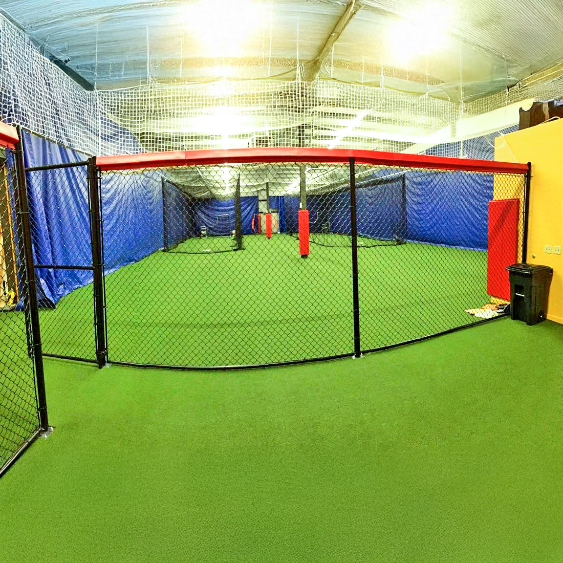 Padding for batting cages at indoor baseball facility.