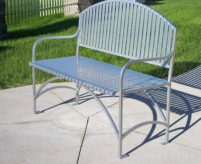 Model #PREB48. Metal outdoor bench in silver for city streets and parks.