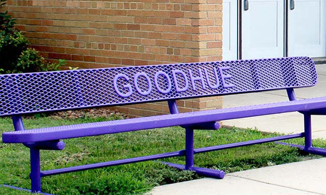 Model #PPS9346L10PP2. School branded 10' purple, free standing buddy bench in front of school.