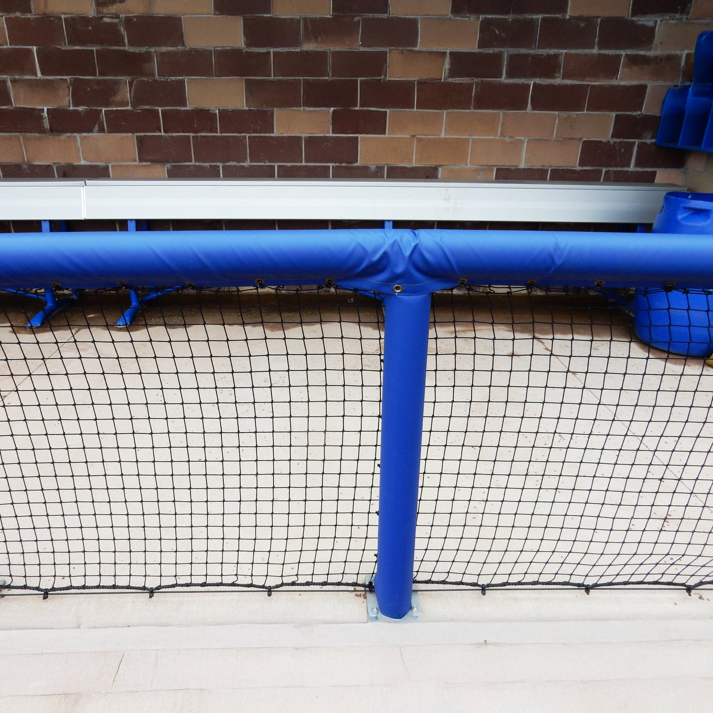 Royal blue padding on dugout rails for baseball or softball dugouts.