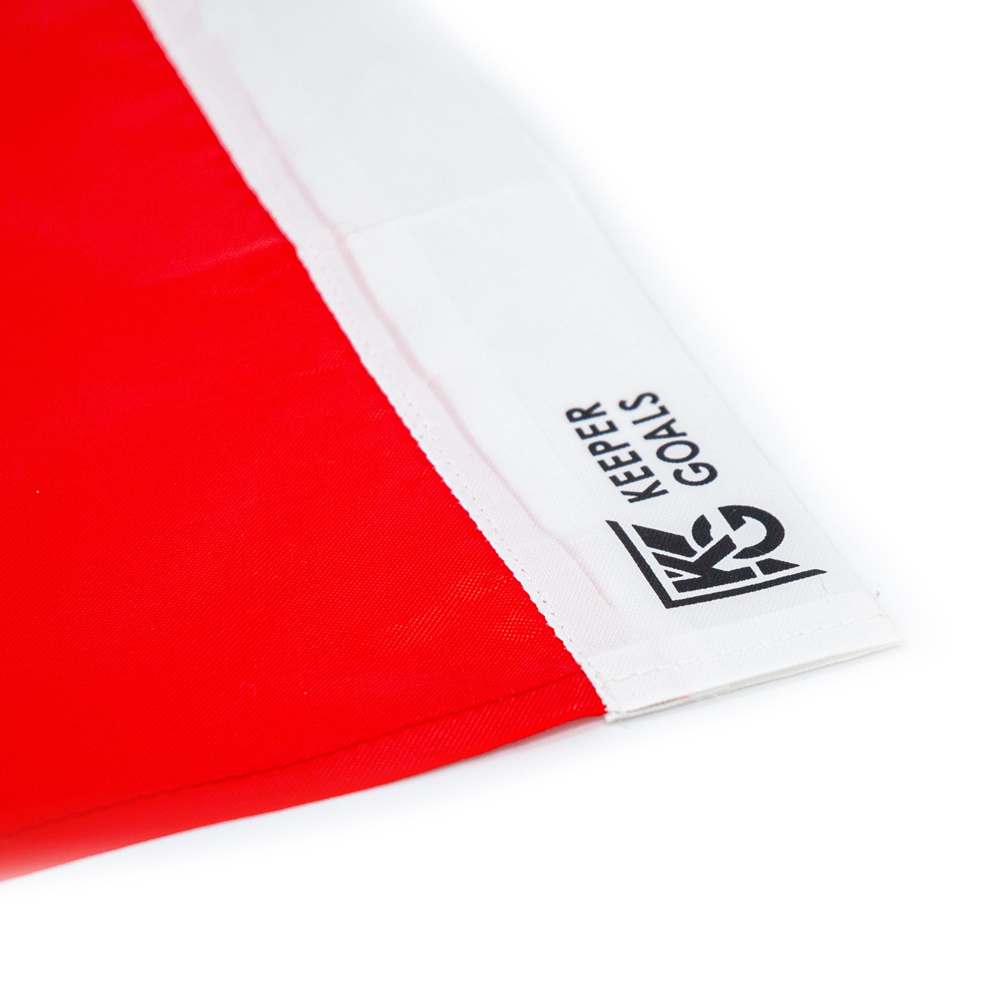 Close-up of the Replacement Corner Flag in red and white nylon with white edges; features the Keeper Goals logo and text printed in black on the white section. Flag only.