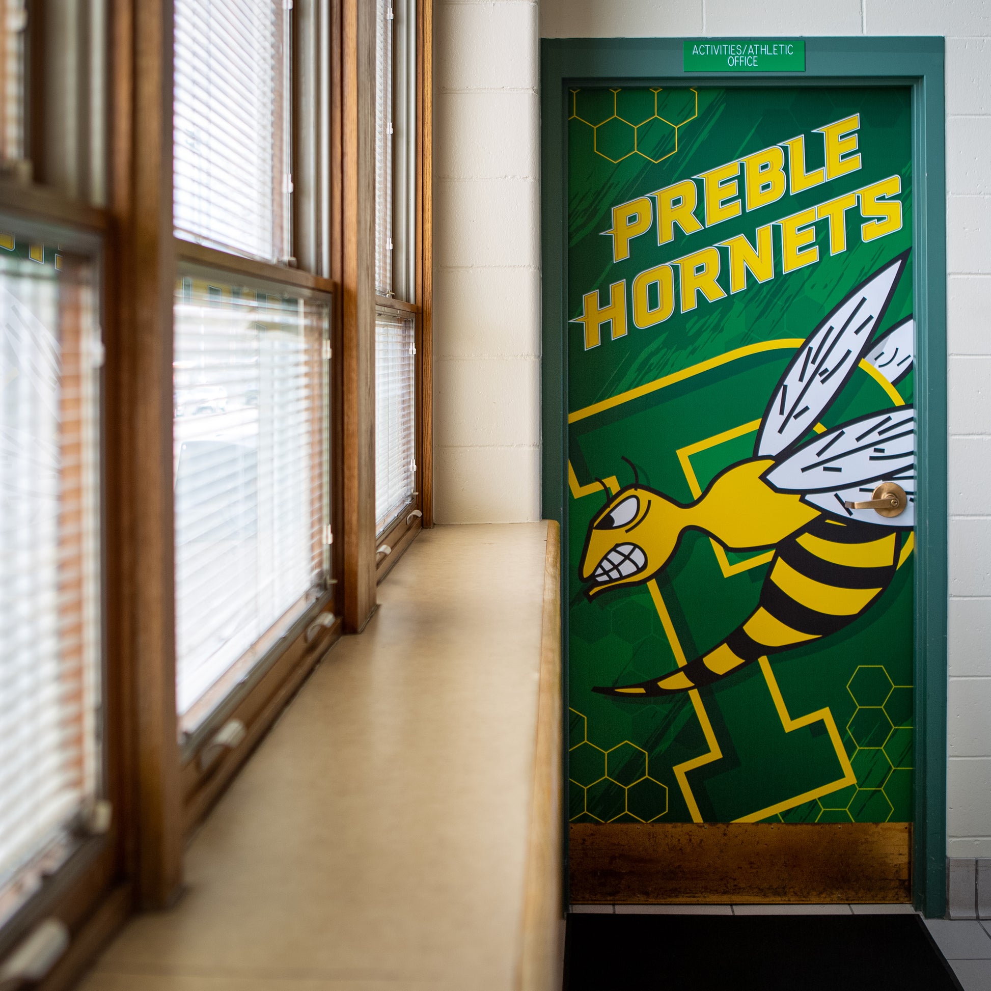 Custom school branding vinyl door wrap.