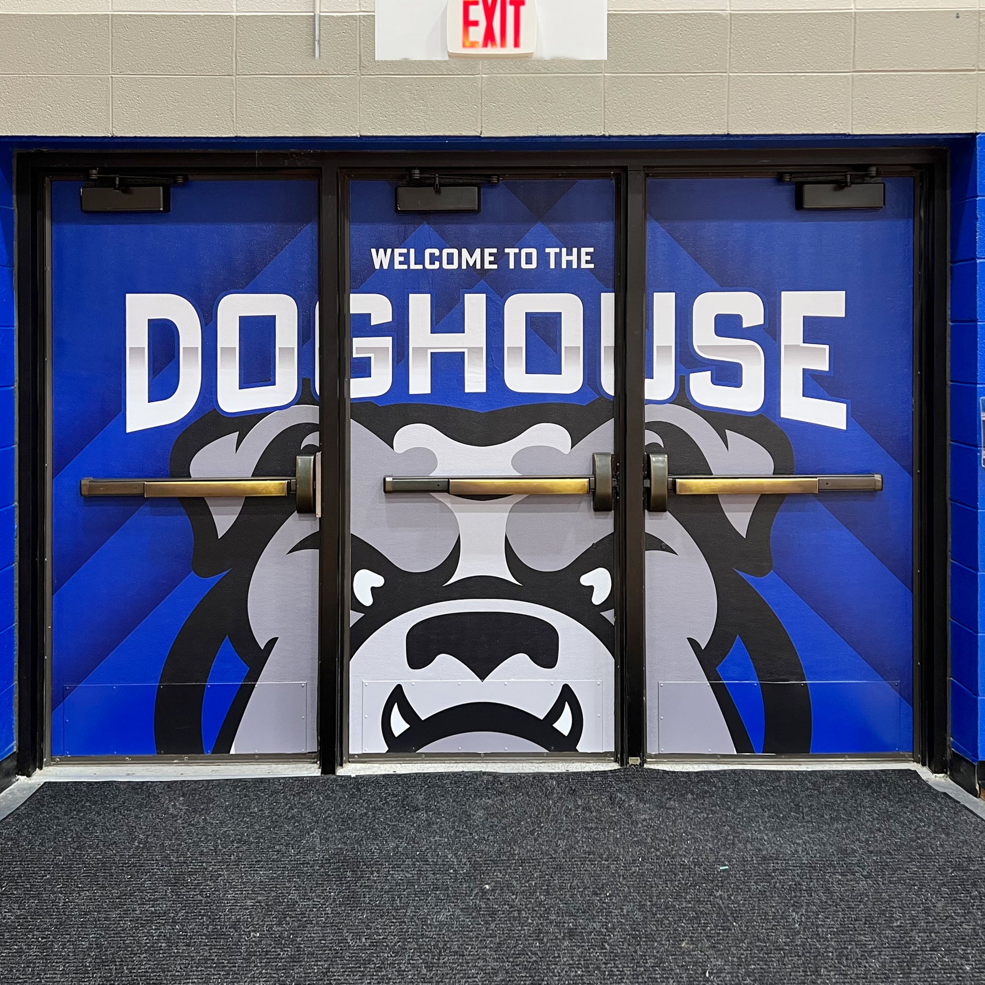 Custom vinyl door wrap triple door gym entrance.
