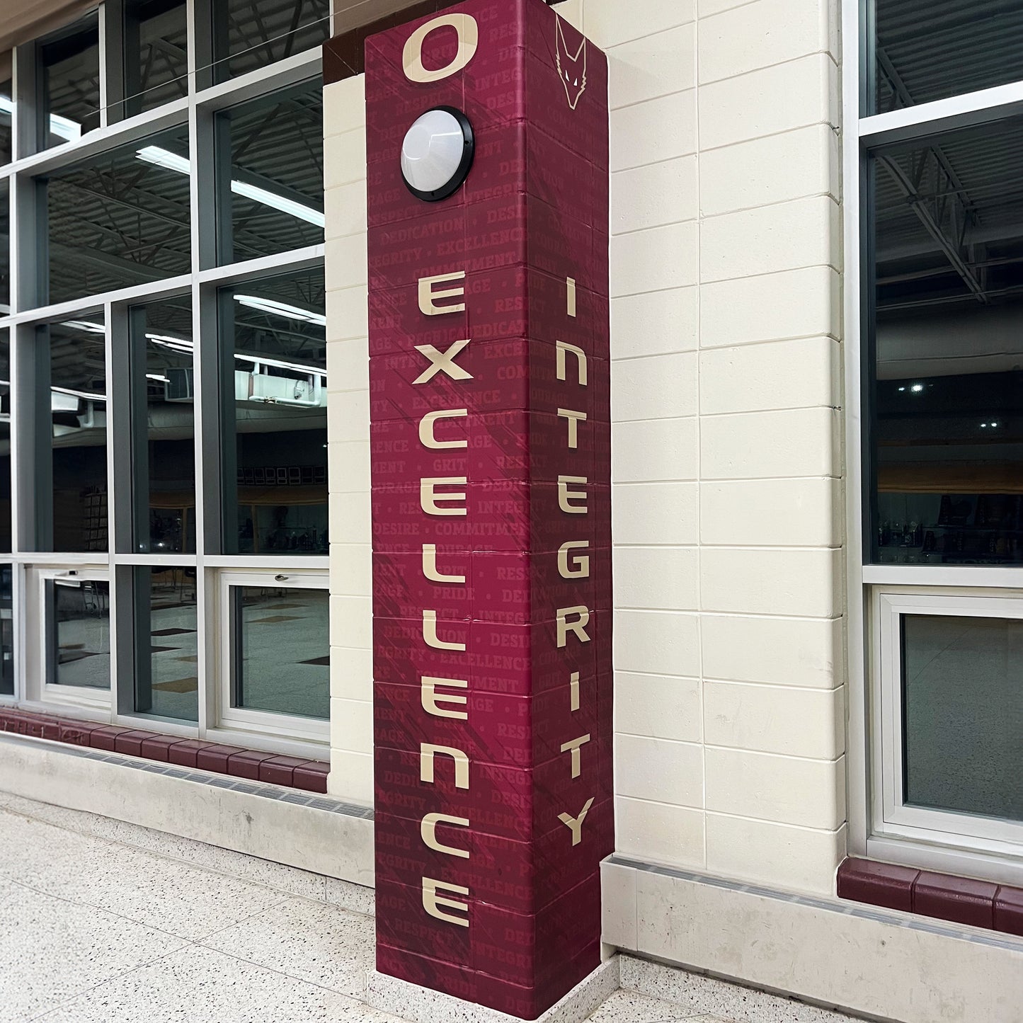 Custom vinyl pillar wrap with school logo.