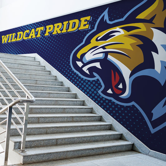 Wildcat Pride vinyl wall wrap in school stairwell. Yellow letters and logo on blue background.