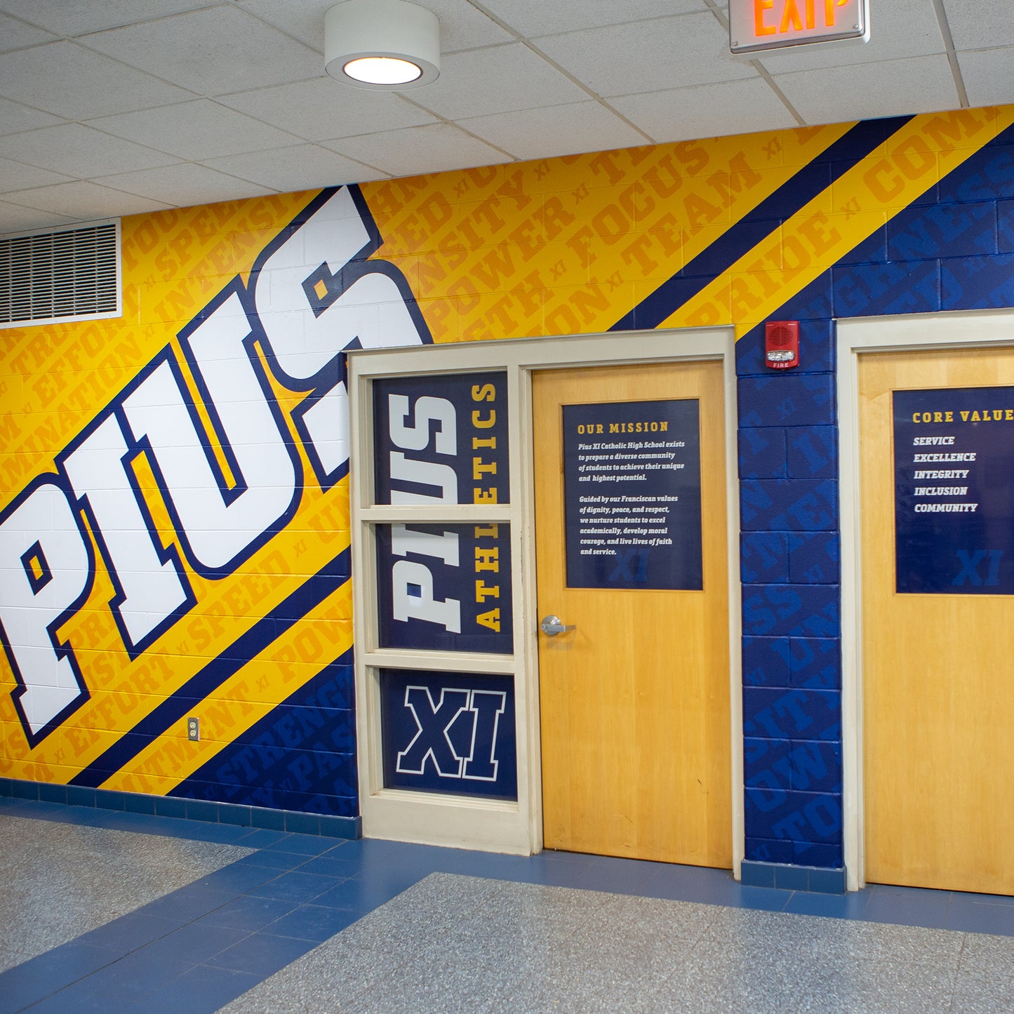 Custom vinyl wall wrap with school branding.