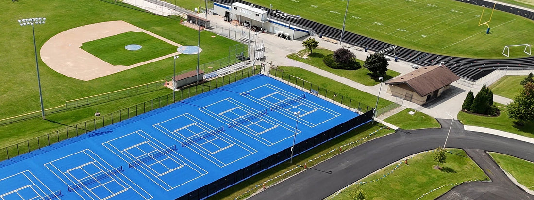Athletic facility upgrades at Howards Grove High School featuring tennis courts, football bleachers, baseball field, and sports equipment installed by Keeper Goals