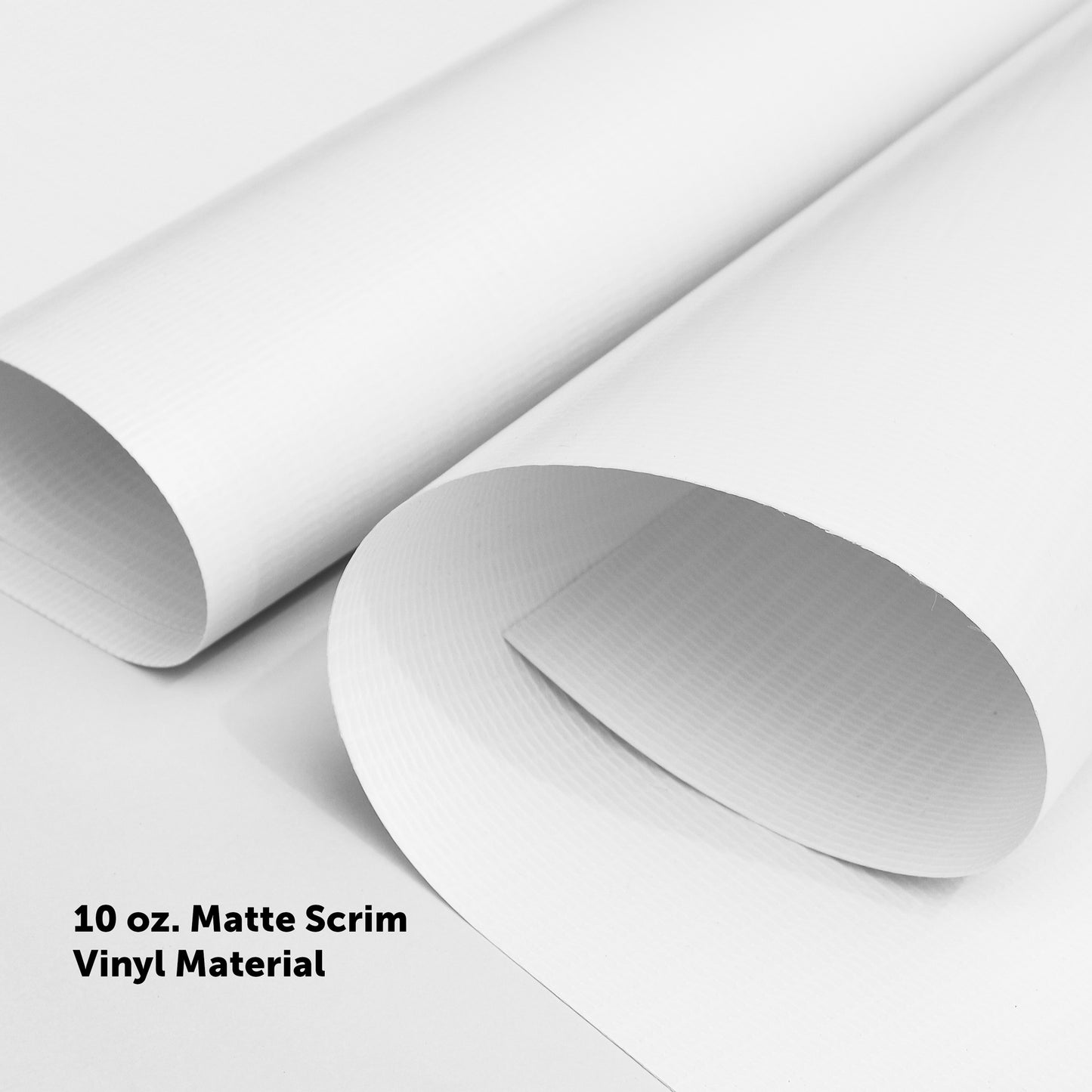 Two rolled sheets of 10 oz. Matte Scrim Vinyl used for Championship Banners are displayed on a white surface, ideal for high school gyms and sports facilities.