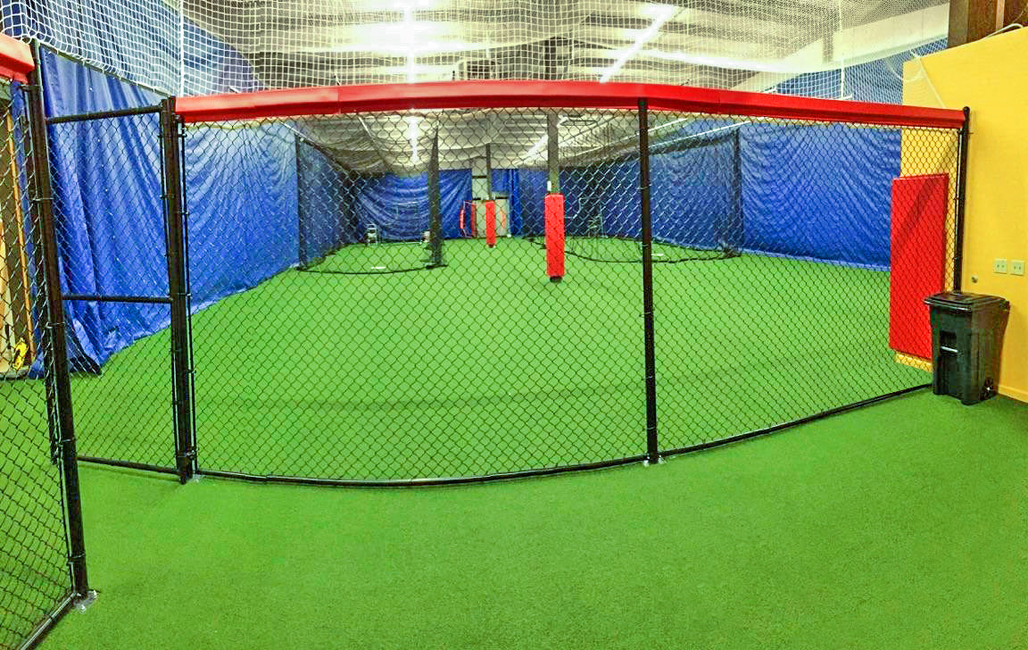Custom padding for batting cage at indoor baseball facility.