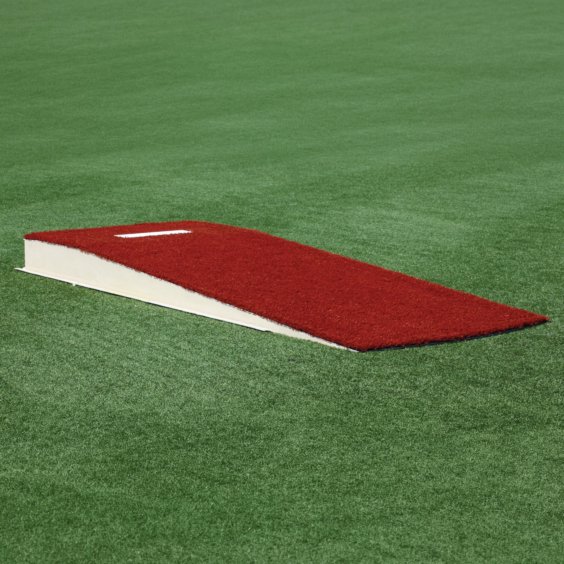 The Perfect Mound Adult Portable Pitching Mound features MLB-spec reinforced fiberglass, a white rubber plate, and sits on a green artificial field for authentic gameplay.