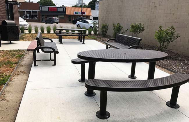Model #PPS9563P5971303AB. Champion oval picnic table. 3' x 6', brown, perforated steel, multi pedestal, surface mount.