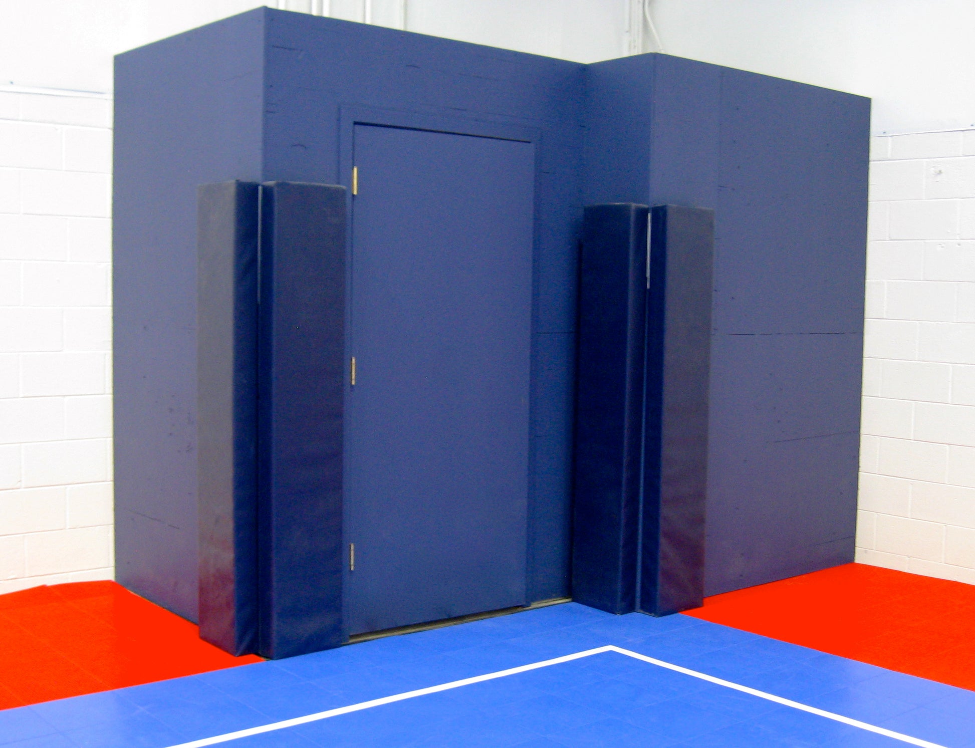 Blue protective padding for futsal field doors.