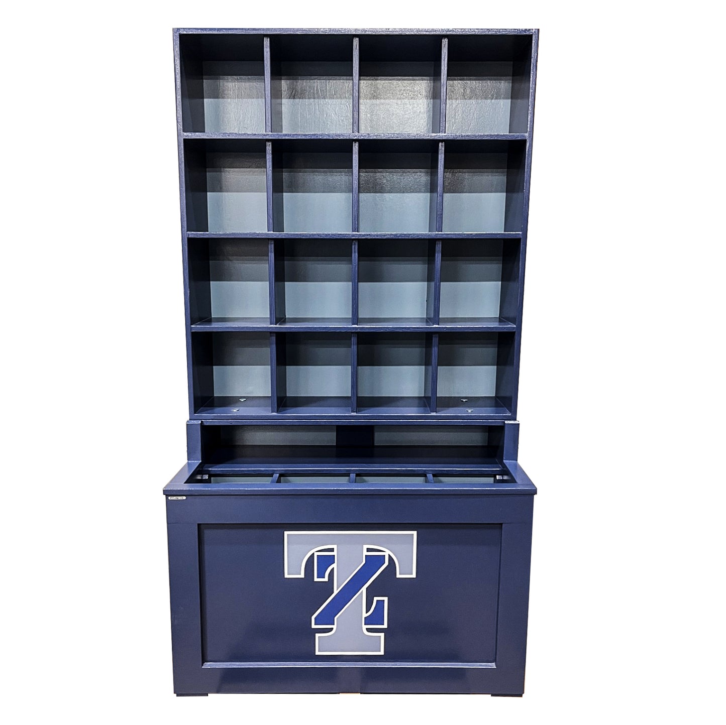The Commander Dugout Helmet and Bat Rack is a blue wooden storage unit with multiple open cubbies above, a closed compartment below, and features a large white and blue T on the front panel. Holds 16 helmets for baseball or softball.