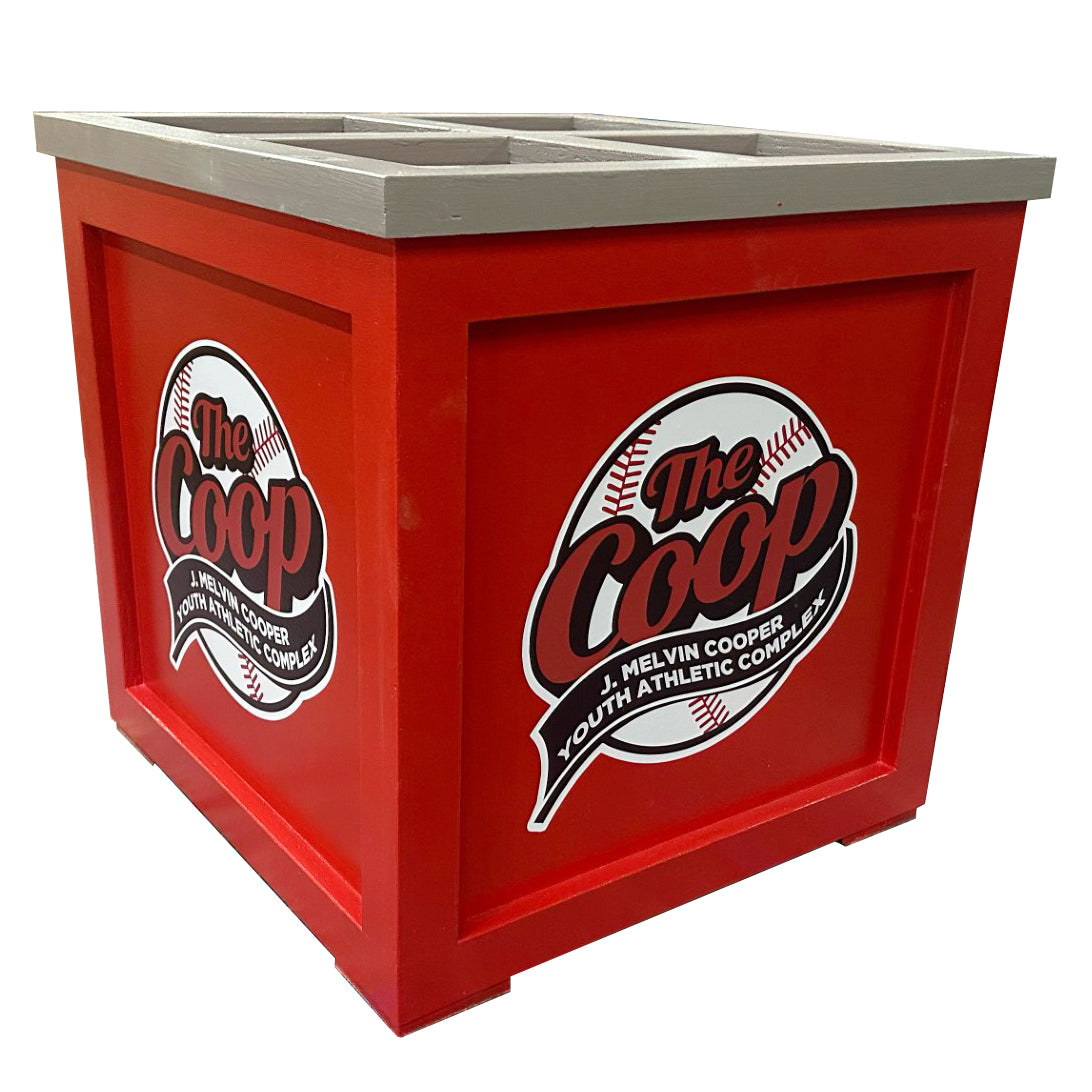 The Grizzly Dugout Bat Storage Unit is a red square bin with a gray top, custom-painted with The Coop Melvin Cooper Youth Athletic Complex baseball logo—perfect MLB-style bat box for organized storage.