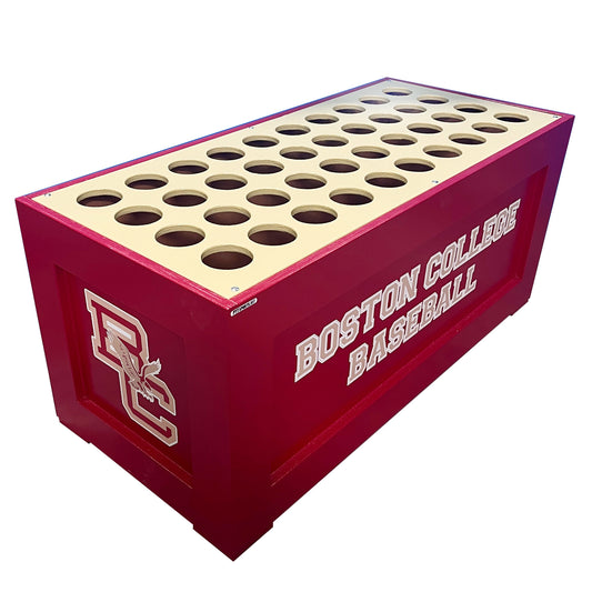 The King Cobra Dugout Bat Storage Unit holds 40 bats and features a rectangular red wood design with Boston College Baseball text, logo, and a cream top surface with multiple evenly spaced circular holes.