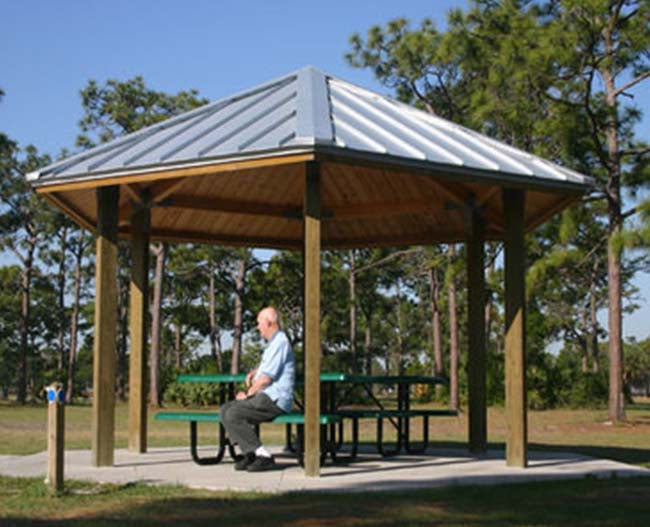 Model #RCPLWHEX20-06. 20' diameter laminated wood hexagonal park shelter with optional metal roofing.