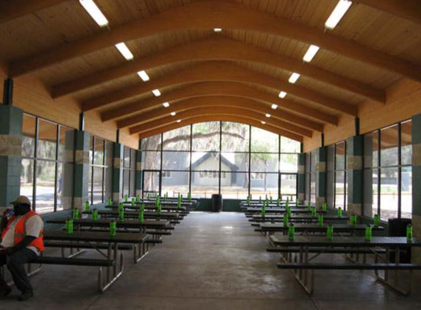 Model #RCPLWENCG45100-03. 45'x100' laminated wood enclosed gable shelter with 2 fixture restroom and storage.