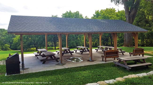 Model #RCPLWOKAG2436. 24'x36' laminated wood open knee arch gable shelter with optional metal roofing.