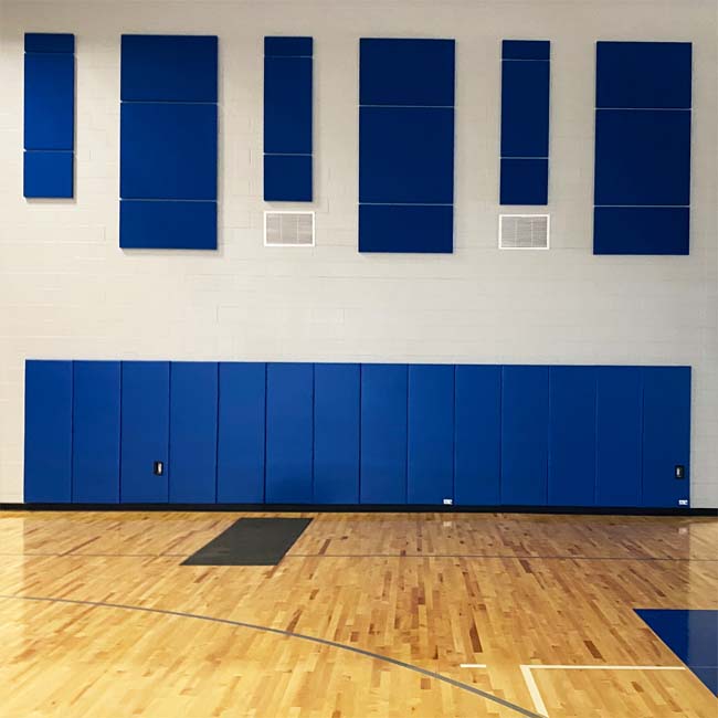 Blue wall padding in gymnasium at Cristo Rey High School.