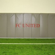Wall padding with custom logo at indoor soccer complex.