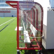 Team shelter with wheels, aluminum benches and red frame.