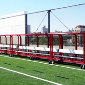 Team shelter with wheels, aluminum benches and red frame.