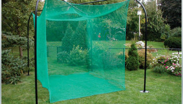 Model #1299GCNHP. Backyard golf cage with green net and black poles.