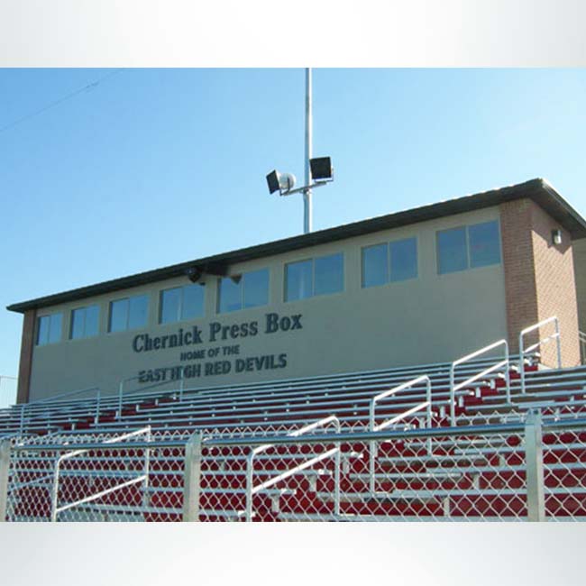 Grandstand stadium seating with press box.