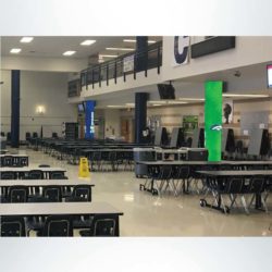 School branding round concrete pillar wraps. Blue and green with logo in school cafeteria.