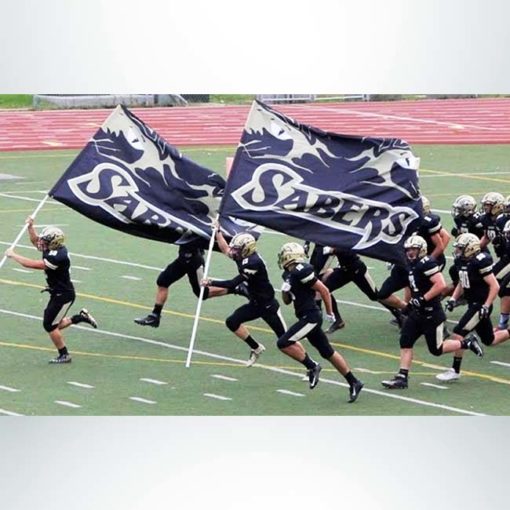Spirit flag with navy blue and white graphic and the word Sabers carried by a football team.