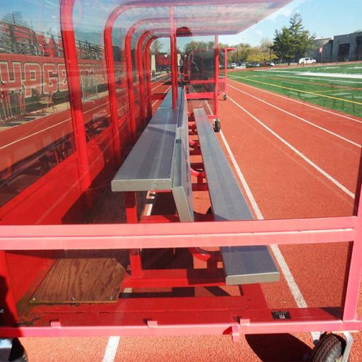 Model #ABS20BUILTIN. 20' aluminum bench with top shelf built into players shelter. Close up side view.
