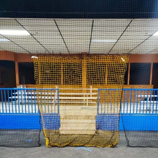 Barrier netting for an indoor futsal facility with a yellow net for a doorway.