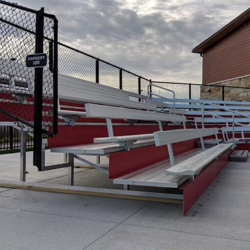 Custom aluminum bleachers with backrest and red risers.