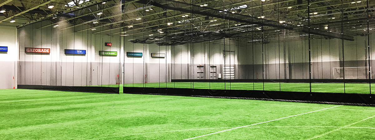 Gym divider in indoor soccer training facility.