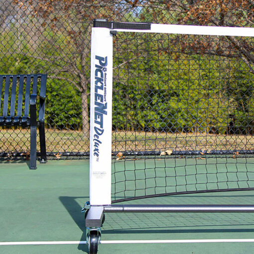 Left post and net of portable pickle ball net system with wheels.